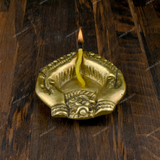 Brass Diya Placed in Welcoming Hand