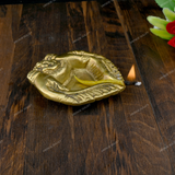 Brass Diya Placed in Welcoming Hand