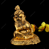 WHITE METAL GOLDEN GANESHA WITH MANJIRA